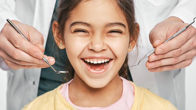 A female teen wearing traditional braces